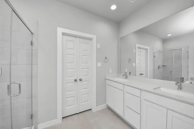 a white bath tub sitting next to a shower