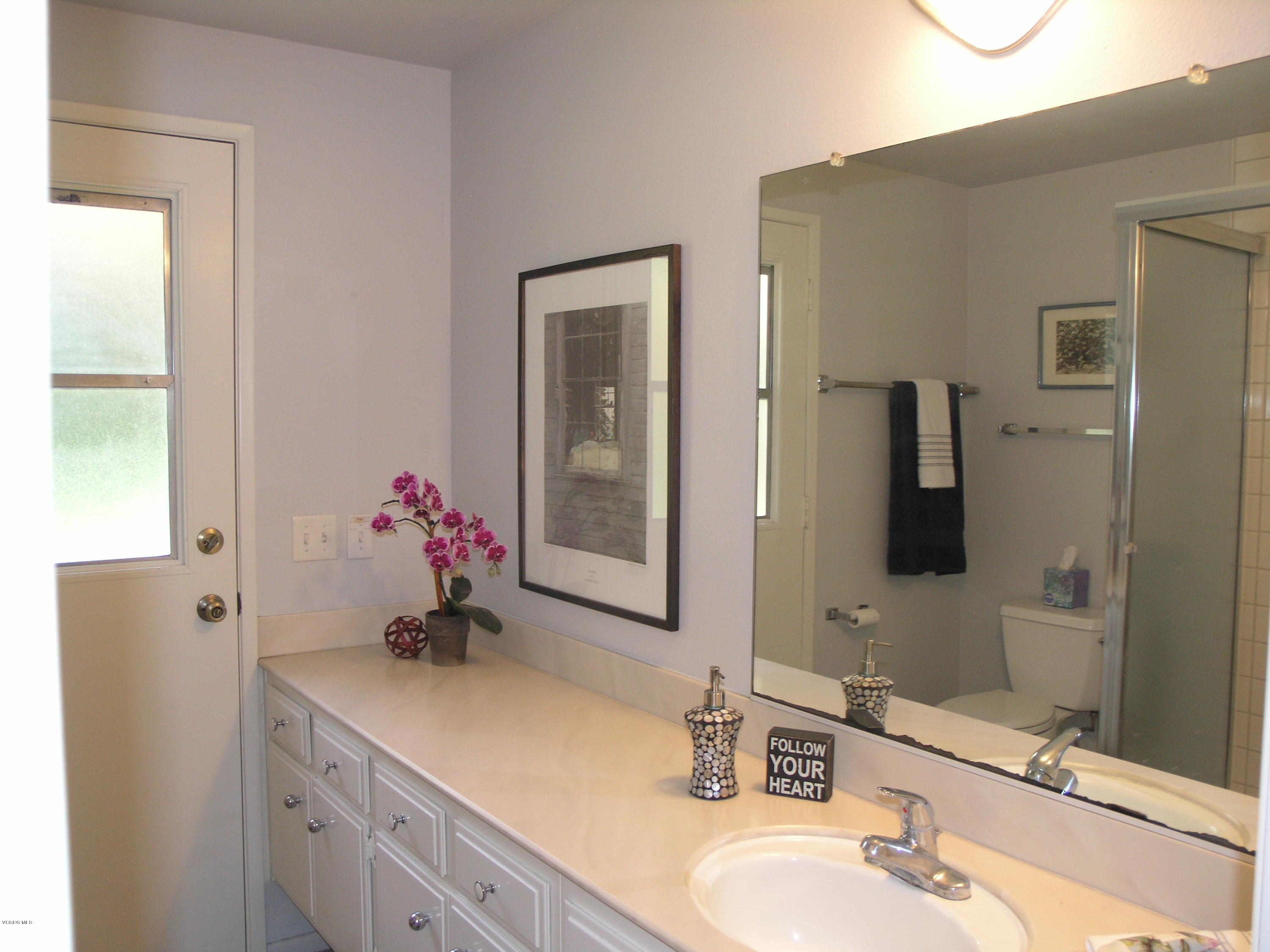398 Day Road Ventura, CA 93003 - Photo 11 of 28 a bathroom with a granite countertop sink and a mirror
