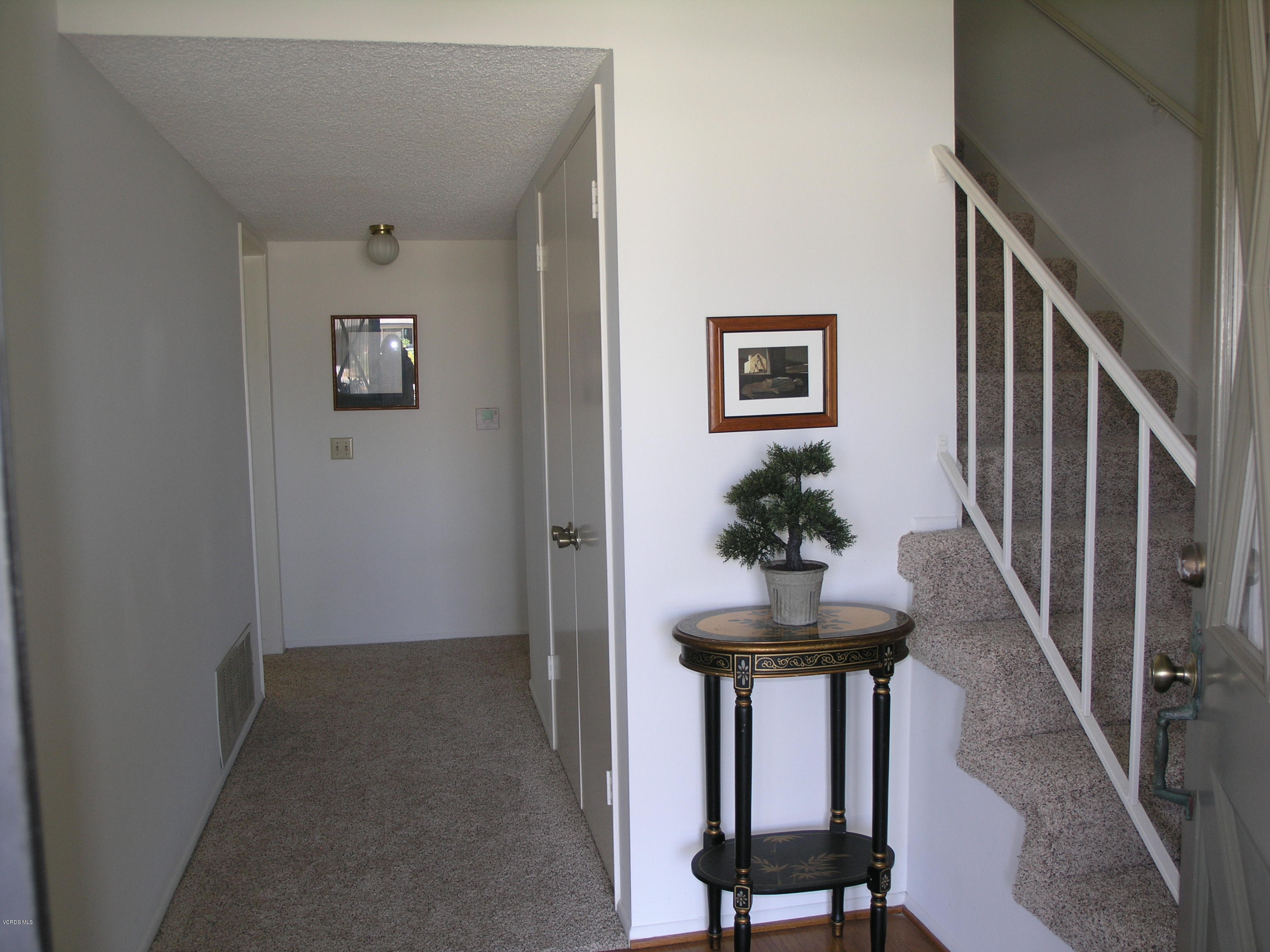 398 Day Road Ventura, CA 93003 - Photo 8 of 28 a view of a hallway with a table and a potted plant