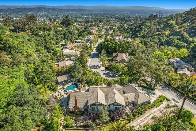an aerial view of a house with a yard