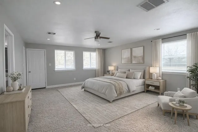 a spacious bedroom with a bed and window