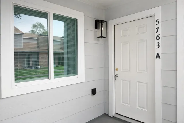 a view of small space with sliding door and wooden floor