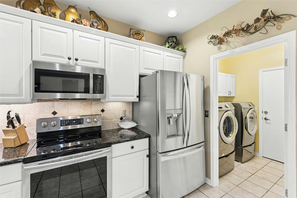 113 Coreopsis Way Georgetown, TX 78633 - Photo 10 of 34 a kitchen with stainless steel appliances a refrigerator stove and white cabinets