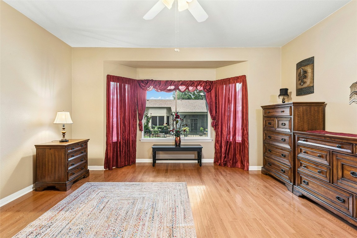 113 Coreopsis Way Georgetown, TX 78633 - Photo 14 of 34 a bedroom with furniture and wooden floor