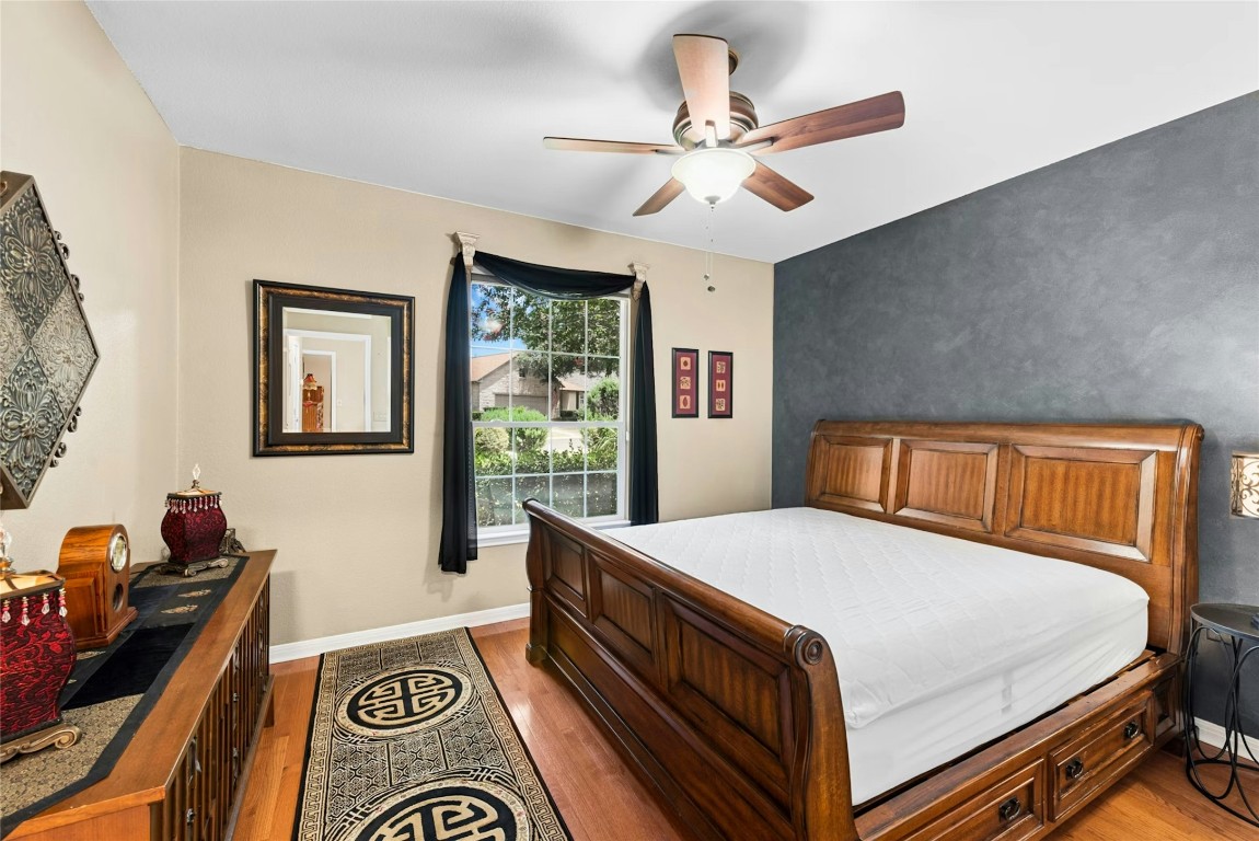 113 Coreopsis Way Georgetown, TX 78633 - Photo 18 of 34 a bedroom with a bed and a chandelier