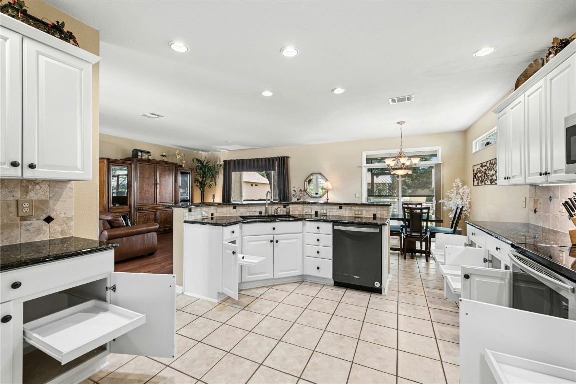 113 Coreopsis Way Georgetown, TX 78633 - Photo 8 of 34 a kitchen with a sink cabinets and stainless steel appliances