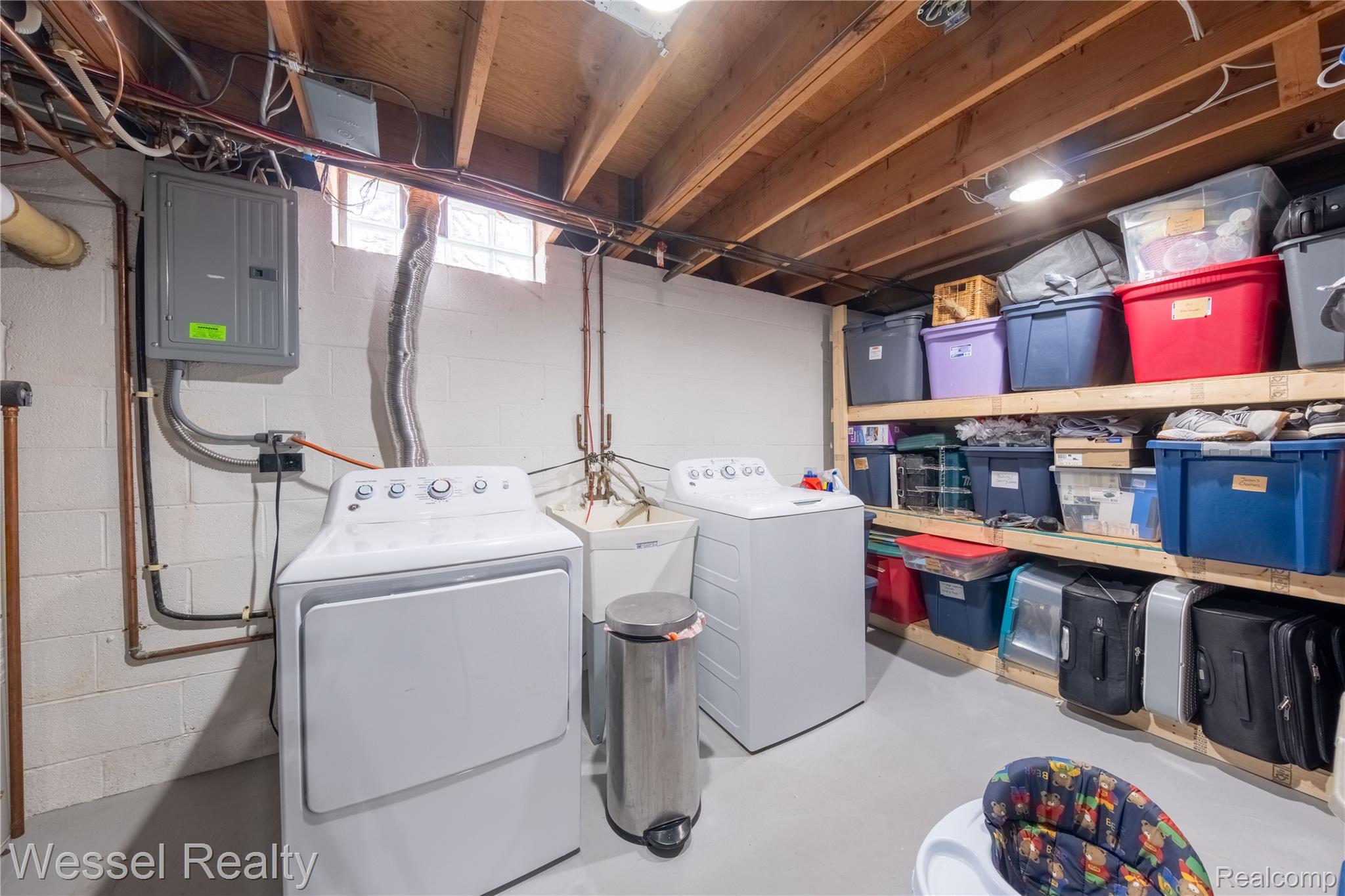 67976 Van Dyke Road, Unit 8 Washington, MI 48095 - Photo 21 of 27 Laundry room featuring electric panel and washer and dryer