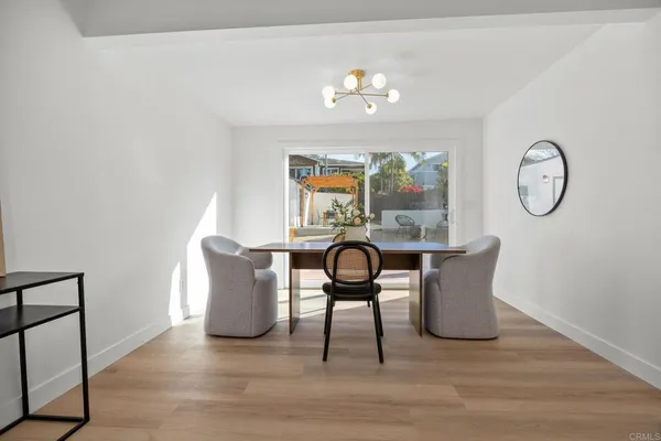 a view of a dining room with furniture and chandelier