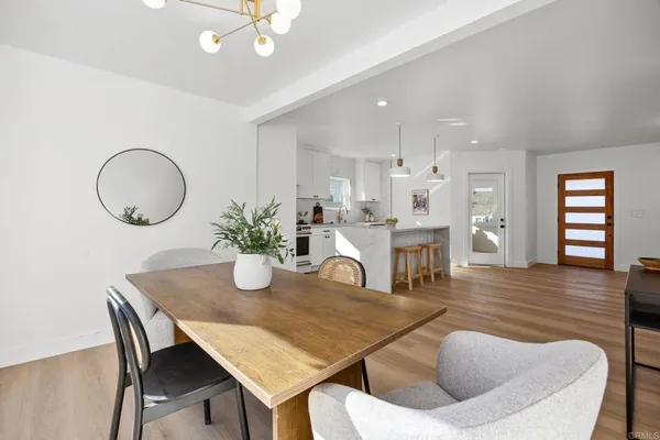 a dining room with furniture and wooden floor