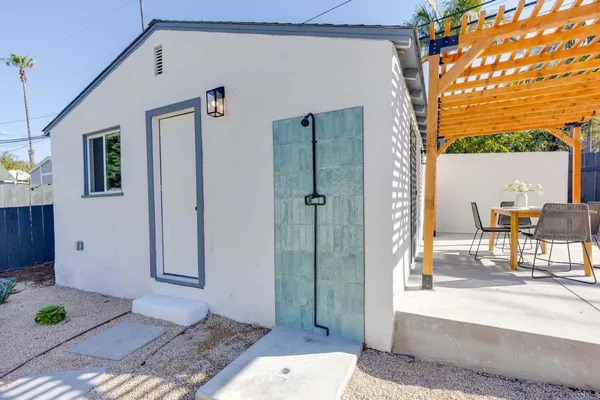 a view of a patio with table and chairs with wooden fence and plants