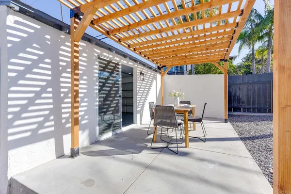 a view of a patio with table and chairs and potted plants