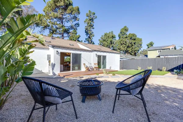 a view of a backyard with wooden fence