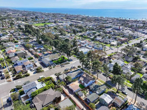 an aerial view of a city with ocean view