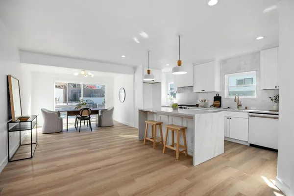 a kitchen with white cabinets and counter space