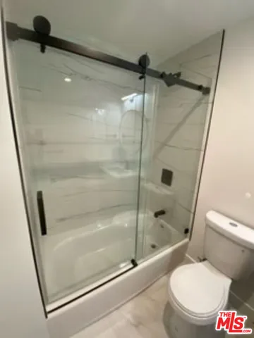 a bathroom with a shower and toilet