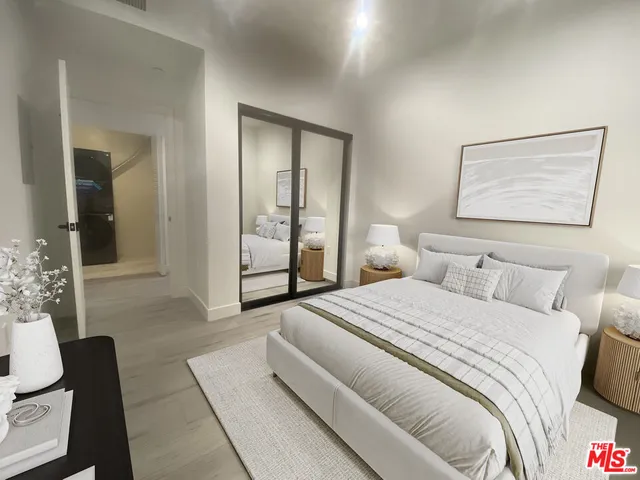 a bedroom with a bed and a painting on the wall