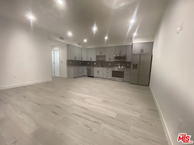 a view of kitchen with cabinets and microwave
