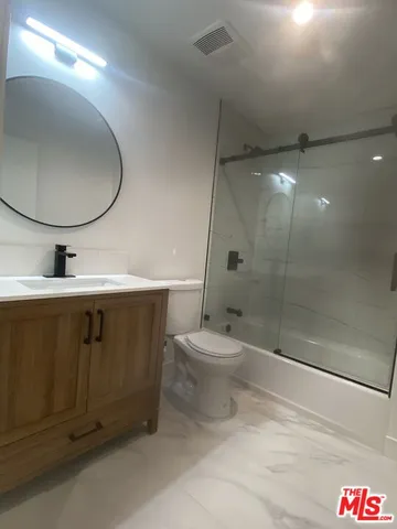 a bathroom with a toilet a sink and shower