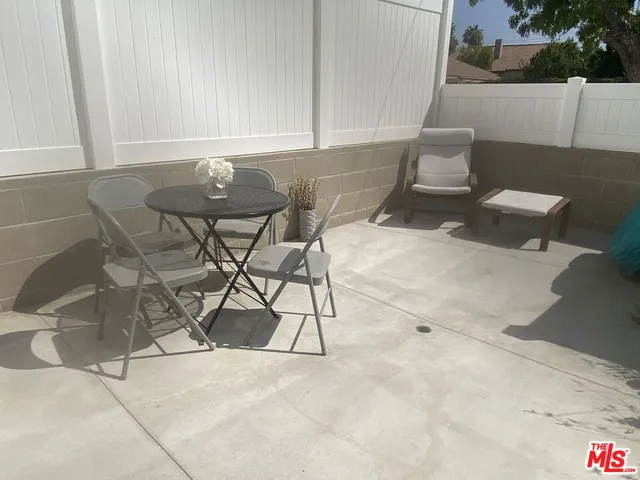 a view of a room with table and chairs