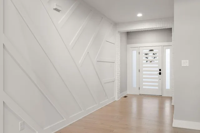 a view of an entryway with wooden floor