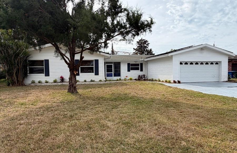 2516 Roberta Street Largo, FL 33771 - Photo 1 of 15 a view of a white house with a yard