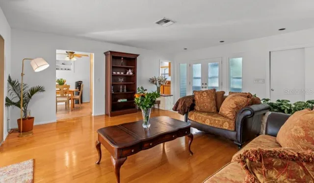 a living room with furniture and wooden floor
