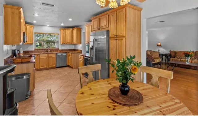 a kitchen with a refrigerator and a stove
