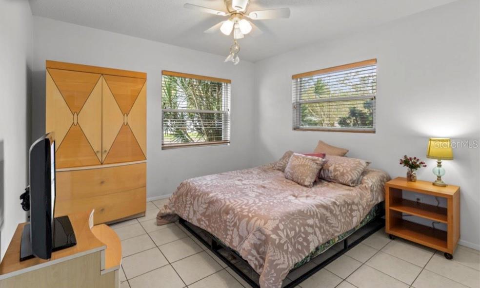 2516 Roberta Street Largo, FL 33771 - Photo 9 of 15 a bedroom with a bed and a chandelier