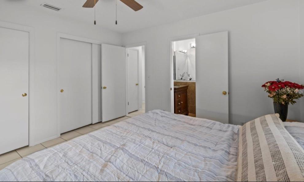 2516 Roberta Street Largo, FL 33771 - Photo 10 of 15 a bedroom with a bed and a chandelier