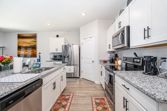 a bed sitting in a bedroom next to a window