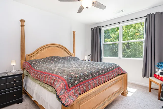 a bedroom with a bed and a dresser