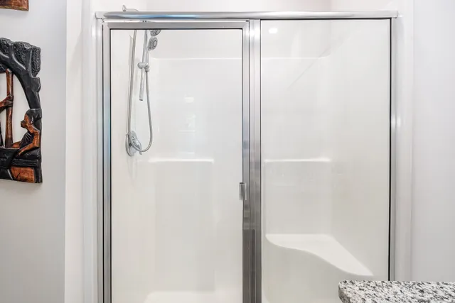 a view of walk in closet with clothes