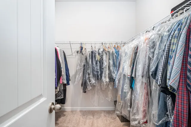 a bedroom with a bed and a large window with the outer view