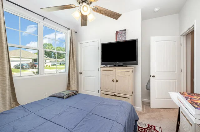 a bedroom with a bed and a window