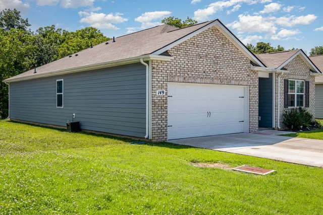 a view of a house with a yard and garage