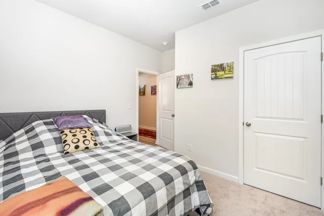 a bathroom with a granite countertop sink mirror vanity and toilet