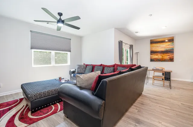 a view of a livingroom with furniture and a window