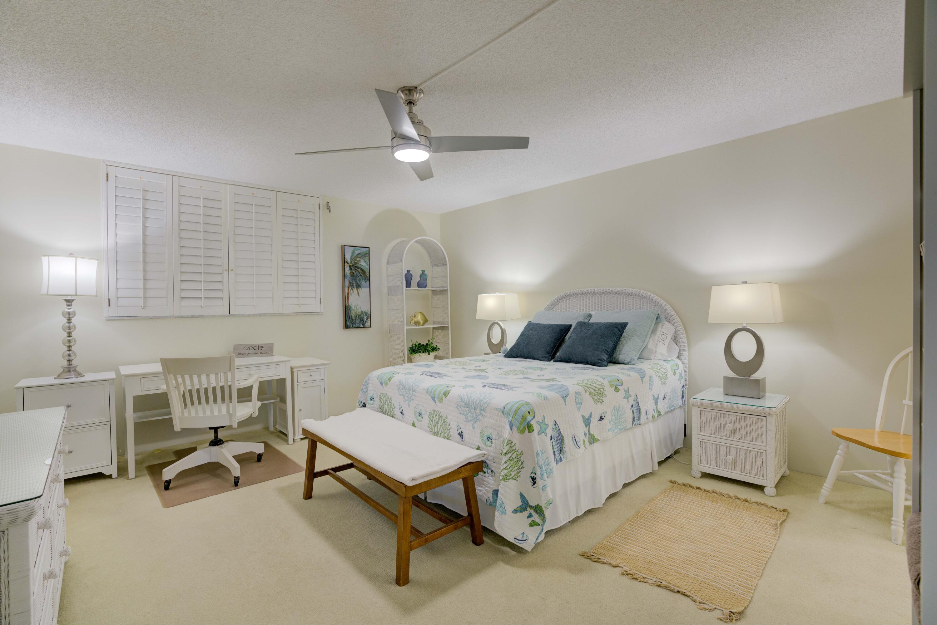 630 Ocean Drive, Unit 302 Juno Beach, FL 33408 - Photo 11 of 40 a spacious bedroom with a bed and a table in it