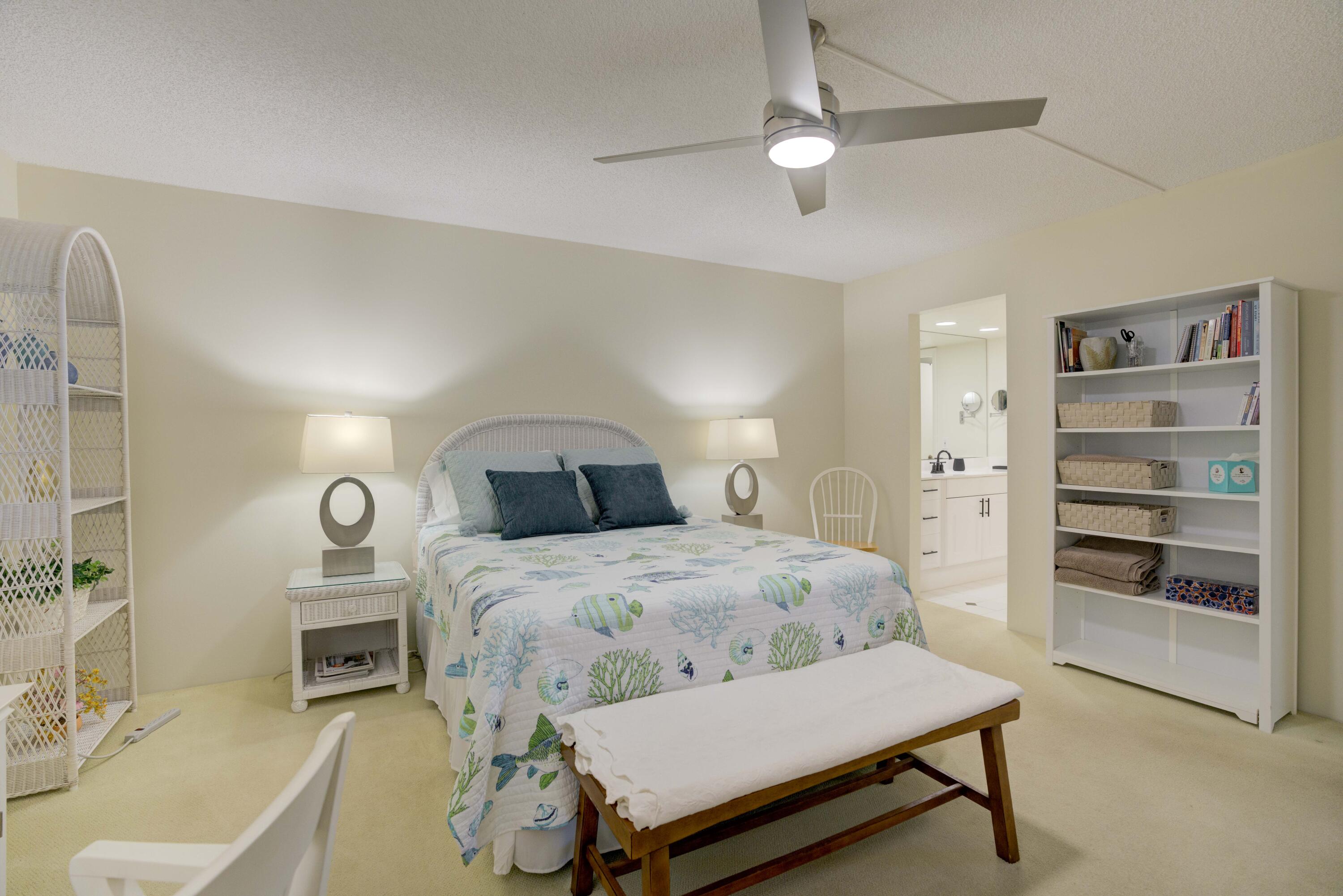 630 Ocean Drive, Unit 302 Juno Beach, FL 33408 - Photo 12 of 40 a bedroom with a bed and a chandelier