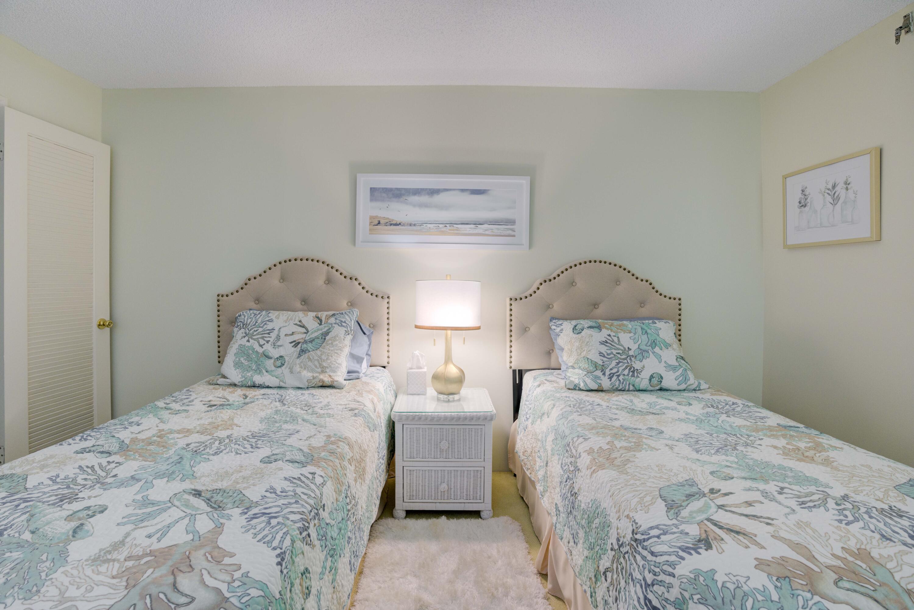 630 Ocean Drive, Unit 302 Juno Beach, FL 33408 - Photo 19 of 40 a bedroom with a bed and a painting on the wall