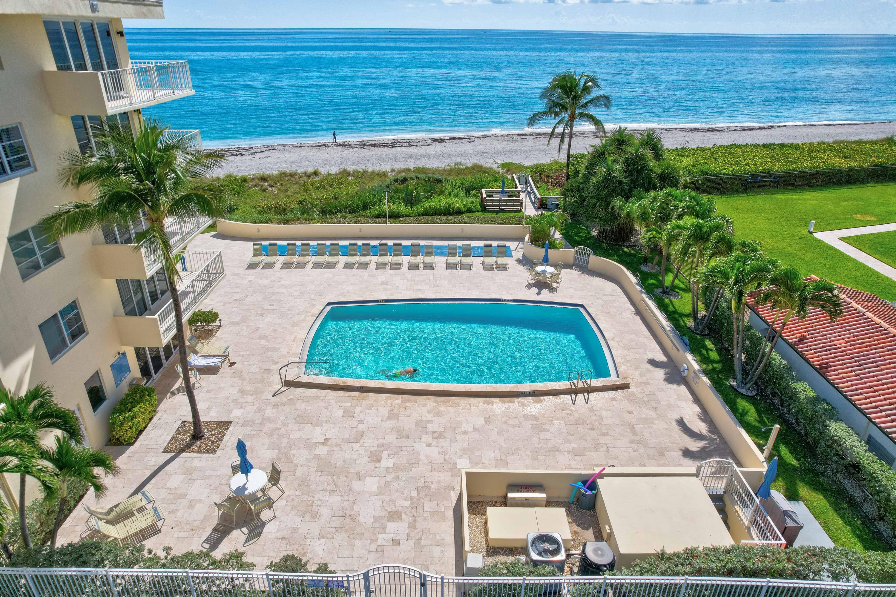 630 Ocean Drive, Unit 302 Juno Beach, FL 33408 - Photo 29 of 40 a view of swimming pool with a yard