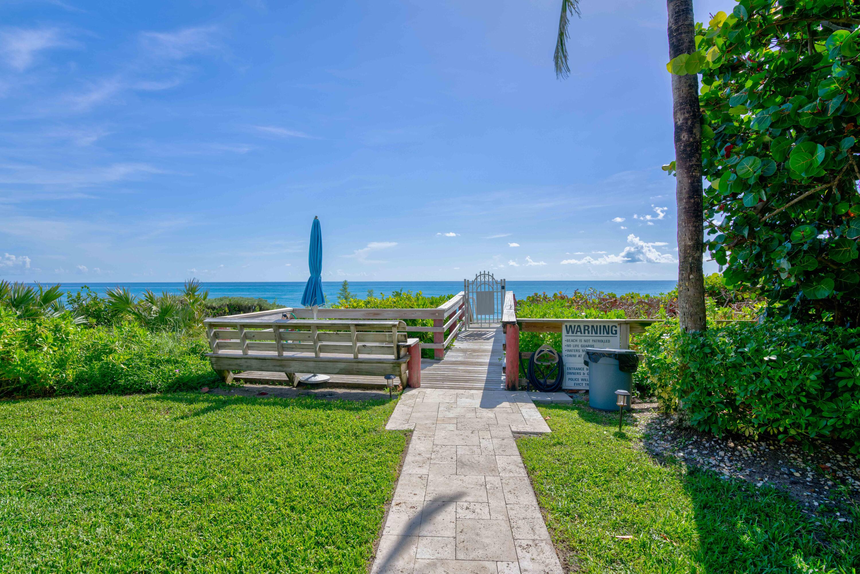 630 Ocean Drive, Unit 302 Juno Beach, FL 33408 - Photo 35 of 40 a view of a bench in the garden