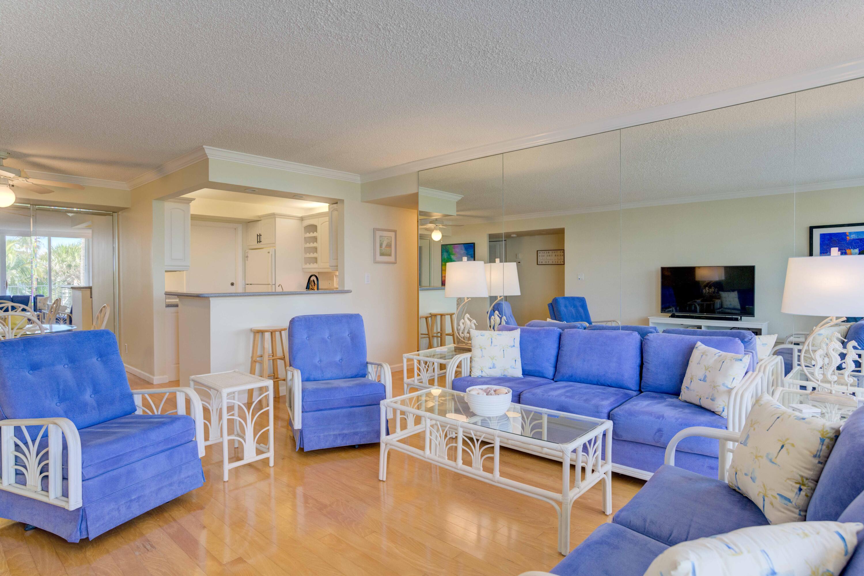 630 Ocean Drive, Unit 302 Juno Beach, FL 33408 - Photo 4 of 40 a living room with furniture or couch and a flat screen tv