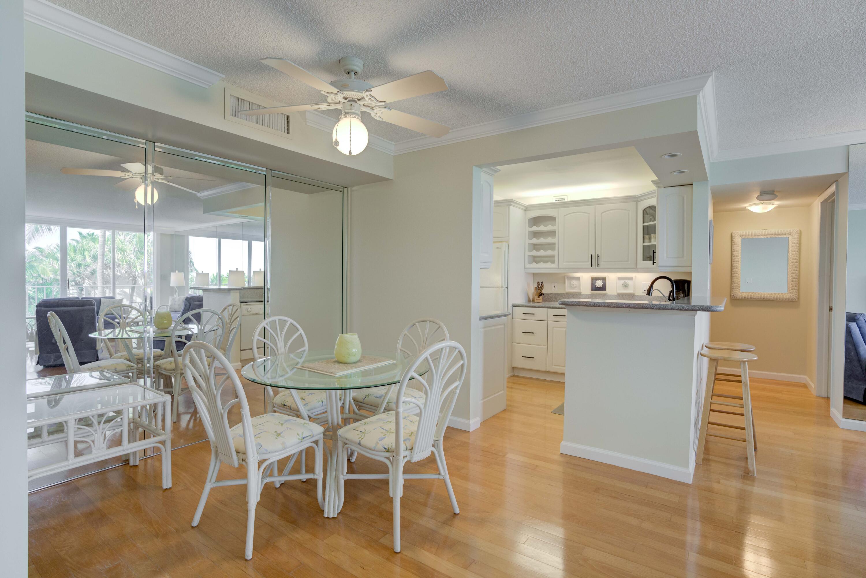 630 Ocean Drive, Unit 302 Juno Beach, FL 33408 - Photo 10 of 40 a view of a dining room with furniture and wooden floor