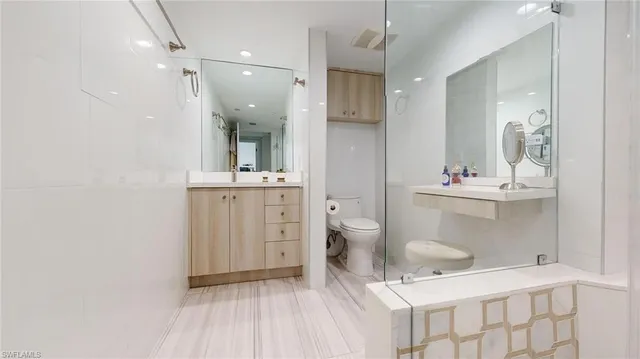 a bathroom with a sink toilet a mirror and vanity