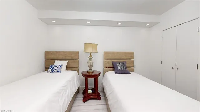 a bed room with a bed and a chair