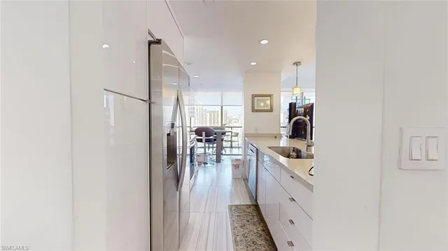 a kitchen with stainless steel appliances a refrigerator and a stove top oven