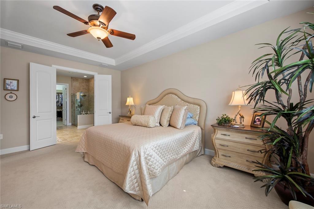 20762 Corkscrew Shores Boulevard Estero, FL 33928 - Photo 15 of 32 a bedroom with a bed and a chandelier