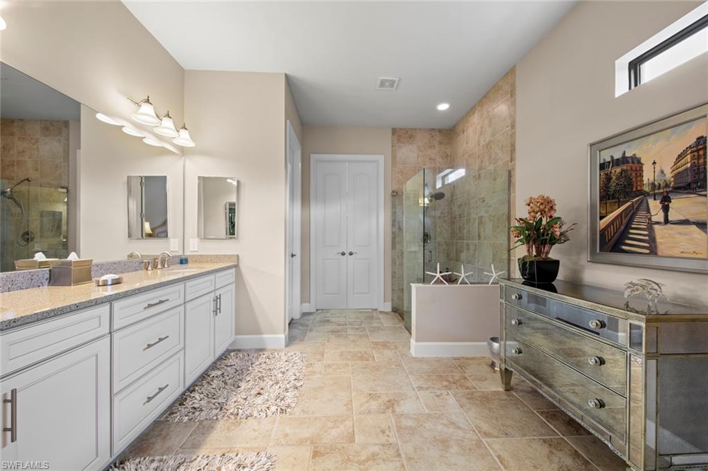20762 Corkscrew Shores Boulevard Estero, FL 33928 - Photo 17 of 32 a bathroom with a double vanity sink mirror and shower