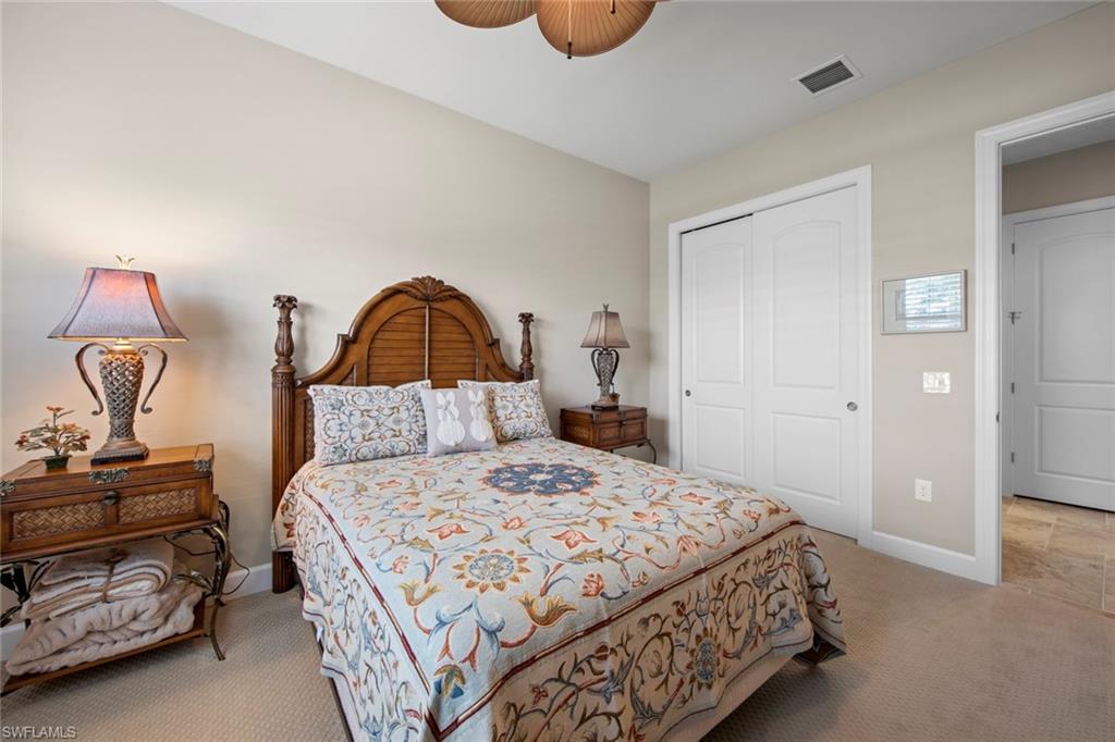 20762 Corkscrew Shores Boulevard Estero, FL 33928 - Photo 18 of 32 a bedroom with a bed and a lamp on dresser